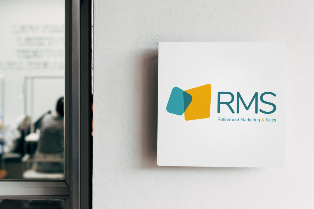 RMS logo printed on a white wall sign and displayed next to an office door