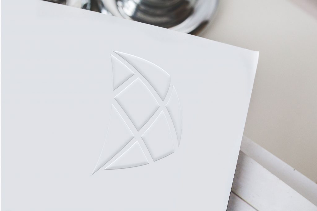 S.I. Group tangram sail icon embossed onto smooth paper