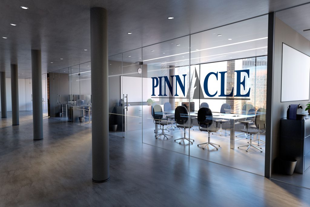 Pinnacle logo decal displayed on a glass office wall outside of a conference room
