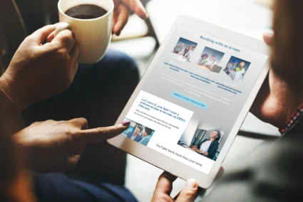 FCG website displayed on a handheld tablet device