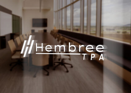 Hembree TPA logo displayed in white on a glass office door
