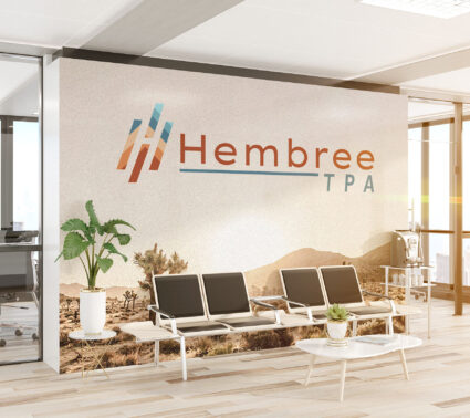 Large Hembree logo decal displayed as a mural on an office wall