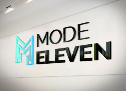 A Mode Eleven logo wall sign